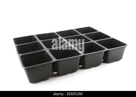 Empty plastic seedling tray isolated on white background. Plastic square plant pots for gardening. Stock Photo