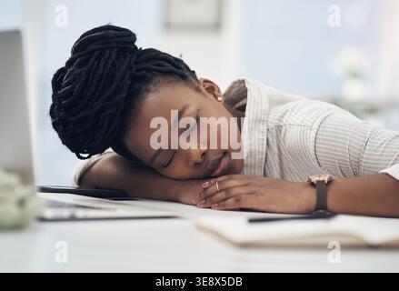 Tired, business and black woman in office sleeping from exhaustion, dreaming and burnout. Female person, laptop and eyes closed for afternoon nap Stock Photo