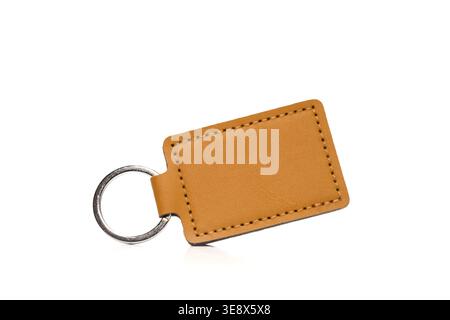 Blank brown leather keychain with metal ring on a white isolated background Stock Photo