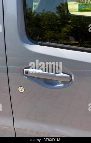 Car Door Handle with Smart Keyless Entry Lock and Unlock Button Close-Up Stock Photo