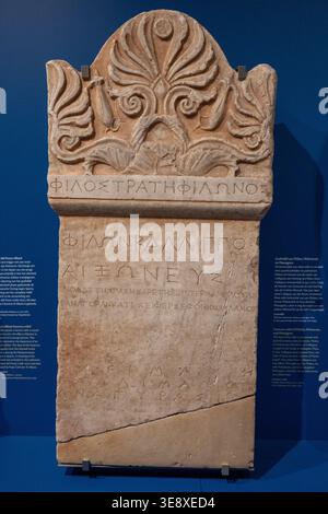 Leiden, Netherlands - 25 May 23: Ancient Greek funerary stele with carved floral motif and Greek inscription displayed at the National Museum of Antiq Stock Photo