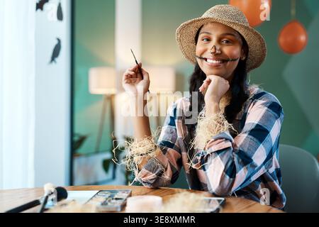 Halloween, portrait and woman with makeup and costume for celebration, dress up and festive event. Happy, creative and person in scarecrow outfit for Stock Photo