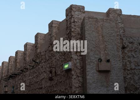 A detailed view of a traditional Qatari architectural wall made of limestone and clay at Souq Waqif in Doha. Stock Photo