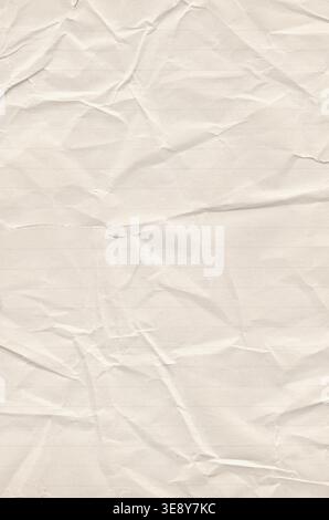 Crumpled lined paper texture background with deep wrinkles, soft folds and aged beige surface tone Stock Photo
