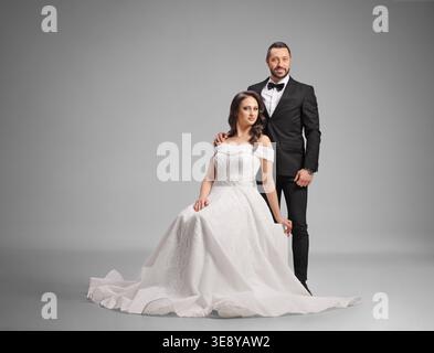 Elegant wedding couple posing in a studio Stock Photo