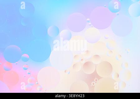 Soft pastel macro texture with blue, cream, and pink bubbles, airy light background, smooth gradients, close-up view, copy space Stock Photo