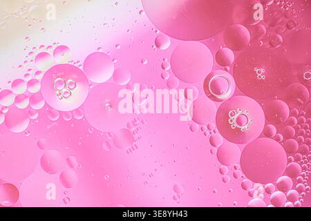 Abstract pink macro texture with translucent bubbles and tiny droplets, soft light background, smooth gradients, close-up view, copy space Stock Photo