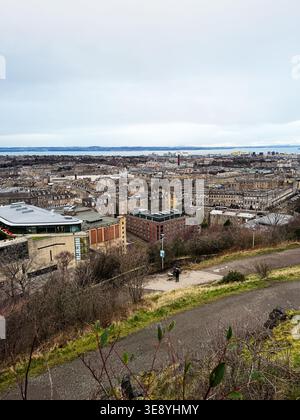 Wide elevated view over Edinburgh, Scotland, UK showing historic architecture, waterfront, overcast sky and tranquil urban landscape. Stock Photo