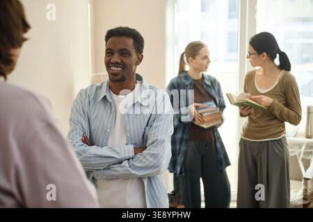 Black Adult Man Networking with Students in Learning Space Stock Photo