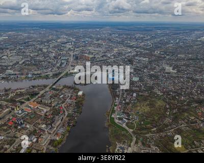 anoramic aerial view of Vinnytsia featuring the Southern Bug River, city bridge and central urban area. The image shows a wide cityscape with water, a Stock Photo