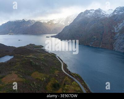 Aerial view of the Lofoten landscape featuring a winding coastal road ...