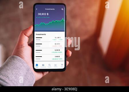 Investment App on Smartphone. Stock Market Portfolio Tracking on Mobile Screen. Banking, personal finance, and online trading. Stock Photo