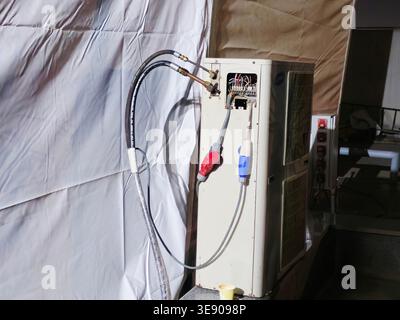 Cairo, Egypt, April 14 2026: the outdoor condensing unit of a split air conditioning system, houses the compressor and condenser coil to transfer heat Stock Photo