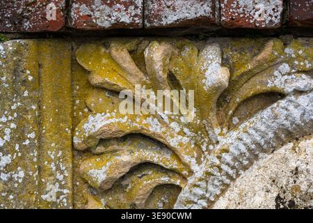 Closeup of carved stone in brick wall for use as a background texture Stock Photo