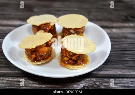 Peanuts small, sweet treats, thin, crispy wafers sandwiching patties of sesame, peanuts or coconut, often held together by honey or sugar, popular on Stock Photo