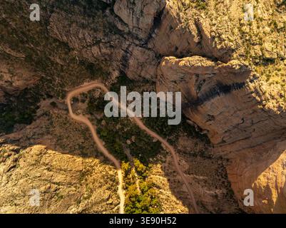 Apache Trail near Phoenix Arizona winding through desert mountains with rugged terrain and scenic canyon views under clear sky Stock Photo