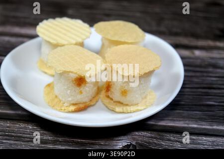 coconut small, sweet treats, thin, crispy wafers sandwiching patties of sesame, peanuts or coconut, often held together by honey or sugar, popular on Stock Photo