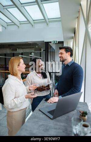 Diverse business professionals collaborating during informal office meeting Stock Photo