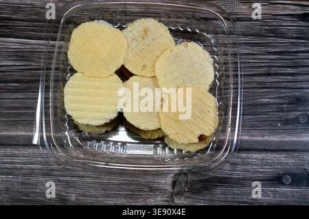Assorted small, sweet treats, thin, crispy wafers sandwiching patties of sesame, peanuts or coconut, often held together by honey or sugar, popular on Stock Photo