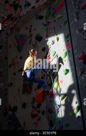 Rocking Wall A climber ascends an indoor bouldering wall in Briançon, Hautes-Alpes ...