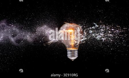 Real Light bulb shattering  dark background Stock Photo