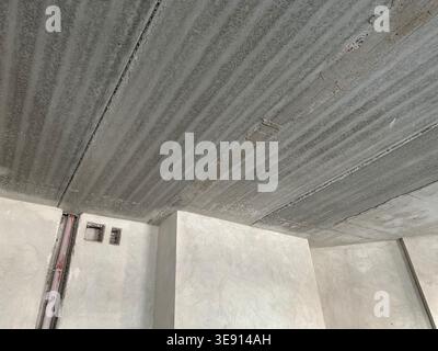 Concrete ceiling prepared for renovation in room, low angle view Stock Photo