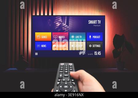 VOD multimedia TV streaming concept with hand holding remote control Stock Photo