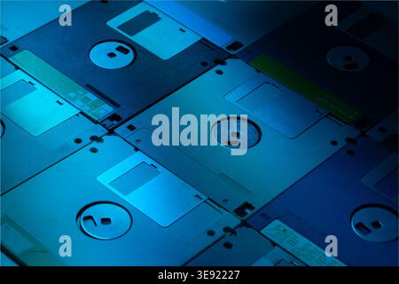 Izmir, Turkey - Apr 16 2026: Close up photo of nine old school 1.6 MB floppy disks arranged with back side facing up on surface illuminated with blue Stock Photo