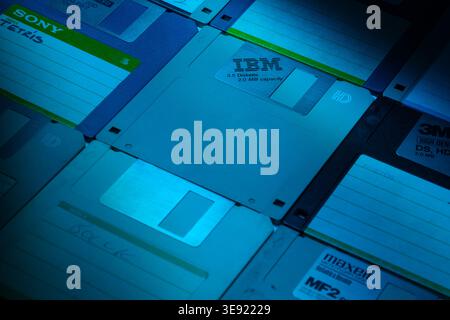 Izmir, Turkey - Apr 16 2026: Close up photo of nine old school 1.6 MB floppy disks arranged flat on surface illuminated with blue colored light Stock Photo