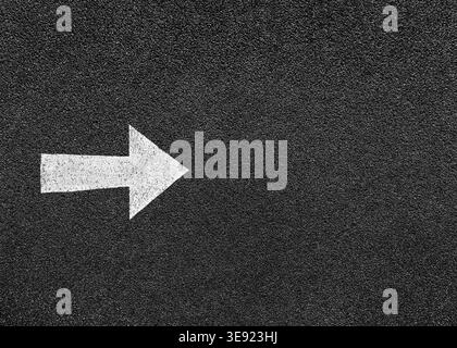 Black background of empty street, asphalt texture with white paint arrow means keep forward. Stock Photo