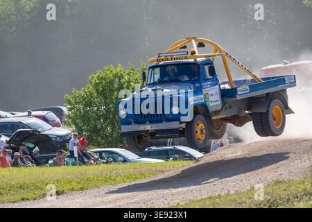 Rally Car Racing on Gravel Road During Motorsport Event in Lithuania Stock Photo