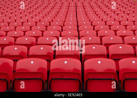 Large section of rows of empty red plastic spectator seats at Anfield stadium, the home of Liverpool Football Club, in Liverpool, England. Stock Photo
