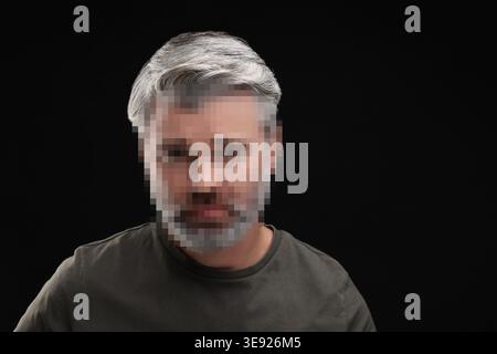 Anonymous man with pixelated face on black background Stock Photo