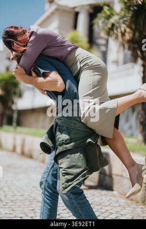 Coworkers sharing a playful piggyback outside an office building on a sunny day Stock Photo