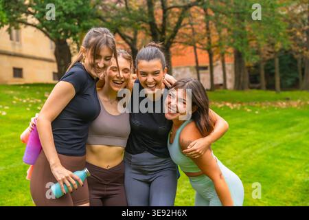 Group of girlfriends laughing posing together outdoors Stock Photo