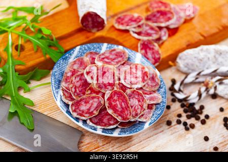 Traditional spanish thin salami sausage Fuet, sliced Stock Photo
