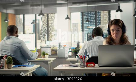 Diverse staff members in office working on forecasting insights. Professional employees review visual data and diagrams to enhance effective management and business goals. Stock Photo