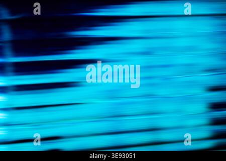 Horizontal bright blue glowing neon light trails with fast motion blur Stock Photo