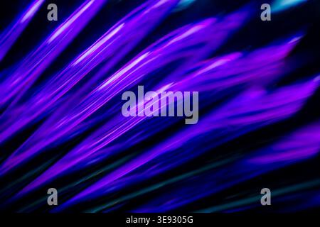 Deep purple diagonal abstract glowing neon light trails in dark space Stock Photo