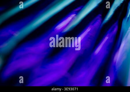 Abstract fluid diagonal waves of glowing blue and deep violet light Stock Photo