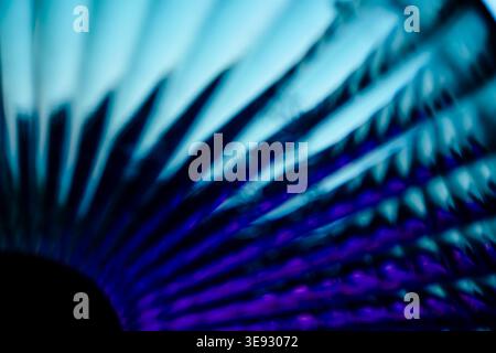Abstract radiating blue and purple lines creating a circular fan pattern Stock Photo