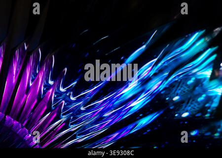 Futuristic cyan and purple illuminated glass texture with sharp dynamic diagonal wave patterns Stock Photo