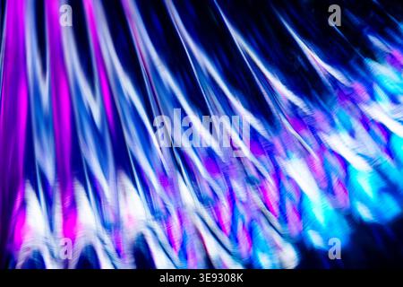 Intricate ripple pattern of blue and purple light reflected in a complex crystalline glass structure Stock Photo
