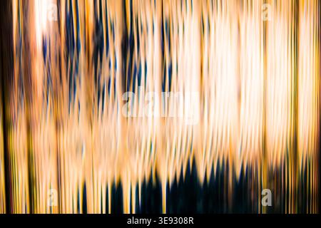 Abstract golden light trails and vertical motion blur creating a warm luminous texture Stock Photo