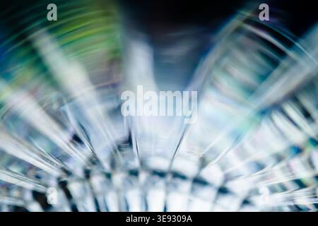 Abstract light refraction through glass creating circular turquoise and blue wave patterns Stock Photo