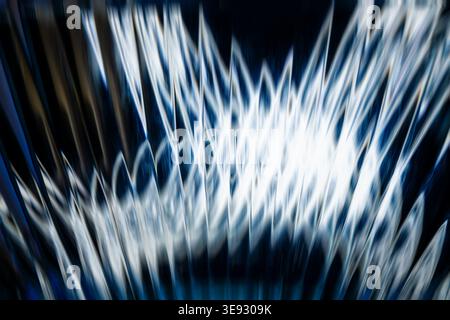 Dynamic abstract blue and white light bursts with geometric jagged patterns Stock Photo