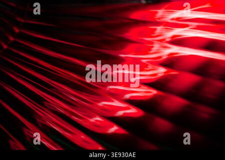 Deep red glowing abstract liquid waves creating a smooth modern background texture Stock Photo