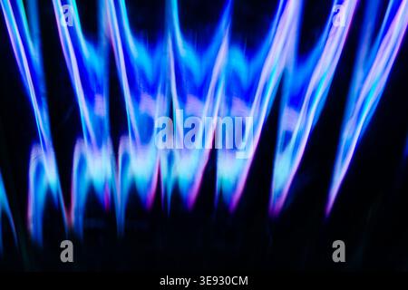 Deep blue and purple vertical flame like light structures Stock Photo