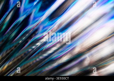 Dynamic iridescent glass surface with diagonal light streaks and rainbow spectrum Stock Photo