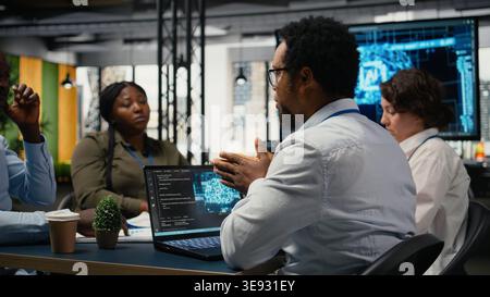 System administrators working in AI startup training predictive models for language processing tasks. Machine learning tech experts use technical expertise for complex IT requirements, camera A Stock Photo